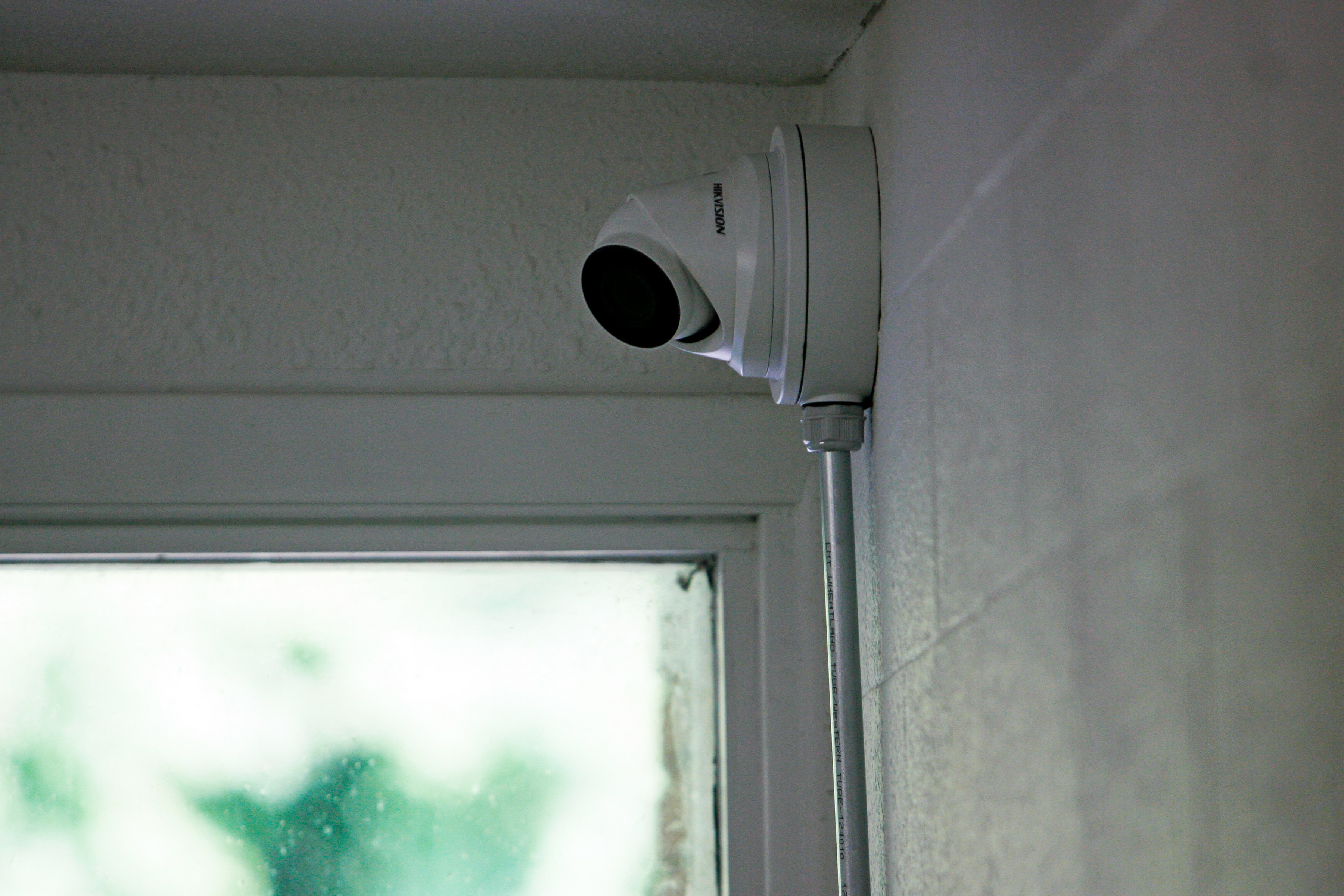 Wired security camera mounted on the exterior of a Southern Utah home