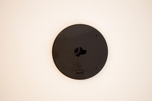 A black Josh AI Nano mounted on a wall