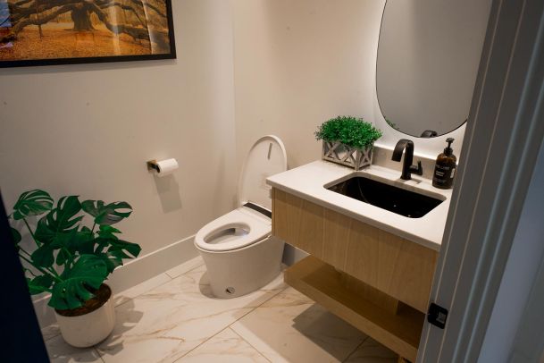 Bathroom with a modern vanity, decorative elements, and warm lighting.