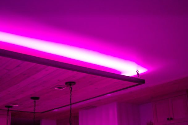 Ceiling with vibrant pink LED lighting creating a striking ambiance. 