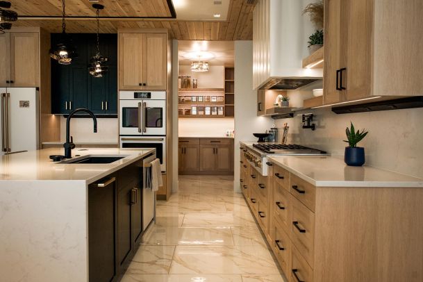 Kitchen view with an island, modern appliances, and an adjoining pantry.