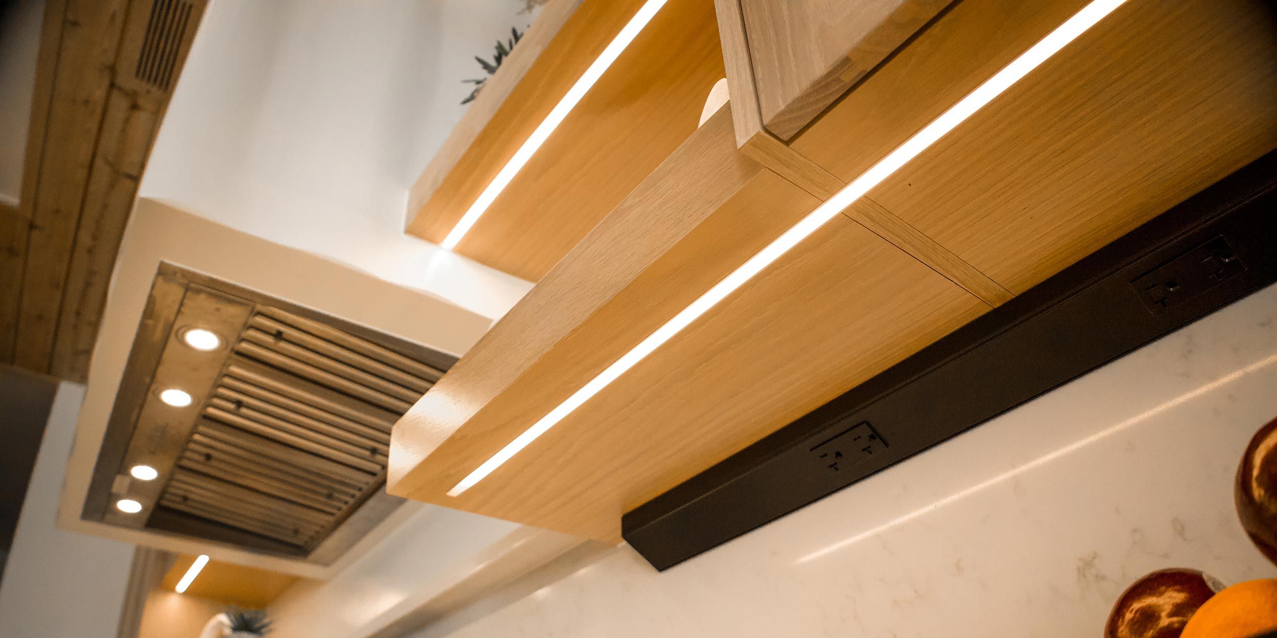 Close-up of under-cabinet LED lighting illuminating a sleek kitchen space.